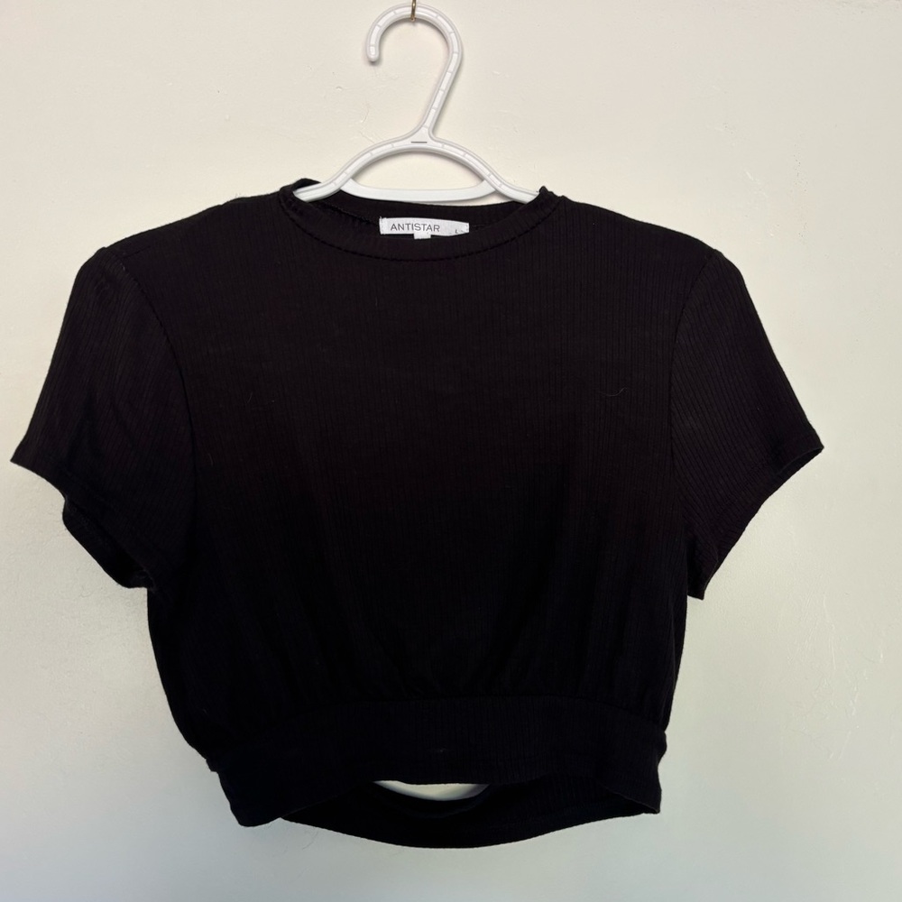 The brand is Antistar, size L, black, ribbed material, cutout in back